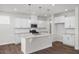 Modern kitchen with white cabinetry, granite countertops, stainless steel appliances and pendant lighting at 82 Fairwinds Dr, Lillington, NC 27546