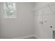 Neutral laundry room featuring a window and a wire shelf at 82 Fairwinds Dr, Lillington, NC 27546