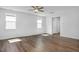 Spacious living room with wood flooring and ample natural light from multiple windows at 82 Fairwinds Dr, Lillington, NC 27546