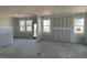 Unfinished living room featuring large windows providing an abundance of natural light at 82 Fairwinds Dr, Lillington, NC 27546