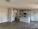 Spacious living room featuring hardwood floors, ample natural light, and an open layout with modern kitchen at 82 Fairwinds Dr, Lillington, NC 27546