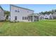 Spacious backyard with lush green grass, patio area, and screened in porch at 936 Jasper Mine Trl, Raleigh, NC 27610