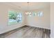 Bright dining room with modern lighting, large windows, and neutral paint at 936 Jasper Mine Trl, Raleigh, NC 27610