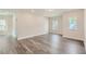 Open living room showcasing hardwood floors, recessed lighting, and natural light from multiple windows at 936 Jasper Mine Trl, Raleigh, NC 27610