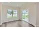Open living space with large window and sliding glass doors leading to outdoor space at 936 Jasper Mine Trl, Raleigh, NC 27610
