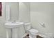 Simple half-bathroom with a pedestal sink and a clean, minimalist design at 1 Red Feather Ct, Durham, NC 27704