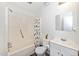Bright bathroom featuring a tub/shower combo with decorative curtain, toilet, and vanity at 100 Forsyth Dr, Chapel Hill, NC 27517