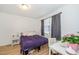 Well-lit bedroom with wood flooring, a comfortable bed, and a workspace area with a modern aesthetic at 100 Forsyth Dr, Chapel Hill, NC 27517