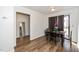 Cozy dining area with wood-look flooring, a simple table set, and sliding glass doors for ample natural light at 100 Forsyth Dr, Chapel Hill, NC 27517
