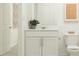 Neutral bathroom with a vanity with storage, toilet, and fresh white paint at 10064 Regal Dr, Angier, NC 27501