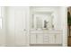 This bright bathroom features double sinks, white cabinets, a neutral palette, and modern fixtures at 10064 Regal Dr, Angier, NC 27501