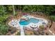 Aerial view of fenced backyard showcasing pool, hot tub, fire pit, and beautifully landscaped grounds at 1017 Holly Creek Ln, Chapel Hill, NC 27516