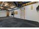 Spacious basement area featuring black rubber flooring, white brick walls, and wall-mounted exercise equipment at 1017 Holly Creek Ln, Chapel Hill, NC 27516