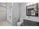 This bathroom has a tiled shower, a gray vanity, and a wooden mirror at 1017 Holly Creek Ln, Chapel Hill, NC 27516