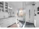 Sleek bathroom with glass shower, white cabinets, and a soaking tub under a window at 1017 Holly Creek Ln, Chapel Hill, NC 27516
