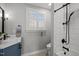 Bright bathroom featuring a blue vanity with modern fixtures and a window with plantation shutters at 1017 Holly Creek Ln, Chapel Hill, NC 27516