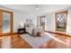 Comfortable bedroom with hardwood floors, neutral colors, and natural light at 1017 Holly Creek Ln, Chapel Hill, NC 27516