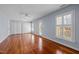 Spacious bedroom with hardwood floors, natural light, and access to the outdoor balcony at 1017 Holly Creek Ln, Chapel Hill, NC 27516