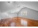 A spacious bedroom featuring hardwood floors, skylight, and plantation shutters at 1017 Holly Creek Ln, Chapel Hill, NC 27516