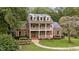 Attractive two-story brick home with double balconies, solar panels, and a well-manicured lawn at 1017 Holly Creek Ln, Chapel Hill, NC 27516