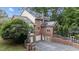 Brick home with a three-car garage and solar panels on the roof at 1017 Holly Creek Ln, Chapel Hill, NC 27516