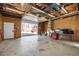 Spacious garage with high ceilings, exposed beams, and an open door leading to the property's exterior at 1017 Holly Creek Ln, Chapel Hill, NC 27516