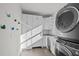 Bright laundry room with modern appliances, white cabinets, and tile flooring at 1017 Holly Creek Ln, Chapel Hill, NC 27516