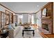 Spacious living room featuring a brick fireplace, hardwood floors, and double doors for seamless indoor-outdoor living at 1017 Holly Creek Ln, Chapel Hill, NC 27516