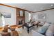 Bright living room featuring a cozy brick fireplace, hardwood floors, and neutral-toned furniture at 1017 Holly Creek Ln, Chapel Hill, NC 27516