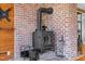 Brick fireplace with black wood-burning stove in a cozy living room area at 1017 Holly Creek Ln, Chapel Hill, NC 27516