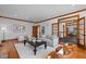 Spacious living room with hardwood floors, wood trim, and large windows, offering ample seating at 1017 Holly Creek Ln, Chapel Hill, NC 27516