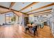 Open-concept living room features hardwood floors, exposed beams, brick fireplace, and a modern kitchen, ideal for gatherings at 1017 Holly Creek Ln, Chapel Hill, NC 27516