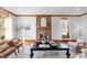 Inviting living room boasts a brick fireplace, wood trim, and ample natural light, creating a cozy atmosphere at 1017 Holly Creek Ln, Chapel Hill, NC 27516
