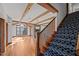 Open concept living space features wood beams, a brick fireplace, and ample natural light, creating a warm ambiance at 1017 Holly Creek Ln, Chapel Hill, NC 27516