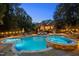 Backyard oasis featuring a uniquely shaped pool, hot tub, and comfortable outdoor seating at 1017 Holly Creek Ln, Chapel Hill, NC 27516