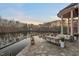 Beautiful back patio features stone flooring, lake views, and comfortable outdoor seating at 102 Anna Lake Ln, Cary, NC 27513