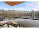 Waterfront balcony with seating area and lake views at 102 Anna Lake Ln, Cary, NC 27513