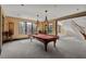 Billiards room featuring a pool table, pendant lighting and large windows with scenic views at 102 Anna Lake Ln, Cary, NC 27513