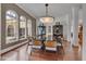 Dining room with statement lighting, display cabinets, and view of yard at 102 Anna Lake Ln, Cary, NC 27513