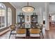 Formal dining room with large windows and a unique light fixture at 102 Anna Lake Ln, Cary, NC 27513