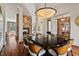 Elegant dining room with a stone fireplace, statement lighting, and seating for eight; perfect for gatherings at 102 Anna Lake Ln, Cary, NC 27513