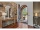 Elegant foyer features stone accent wall, wood floors, arched doorway, and decorative console table with mirror at 102 Anna Lake Ln, Cary, NC 27513