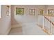 Carpeted upstairs hallway with a classic white railing and abundant natural light streaming through multiple windows at 102 Anna Lake Ln, Cary, NC 27513