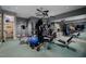 Home gym with mirrored wall, and a wide array of fitness equipment for a complete workout experience at 102 Anna Lake Ln, Cary, NC 27513