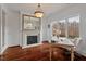 Bright home office featuring a fireplace, desk, and beautiful water views at 102 Anna Lake Ln, Cary, NC 27513