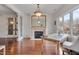 Bright home office with wood floors, fireplace, desk, and water views at 102 Anna Lake Ln, Cary, NC 27513