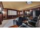Home theater with comfortable leather seating, a large screen, projector, and wood trim at 102 Anna Lake Ln, Cary, NC 27513