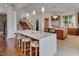 Bright, open kitchen featuring an expansive island with seating and modern stainless steel appliances at 102 Anna Lake Ln, Cary, NC 27513