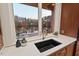 Modern kitchen sink with quartz countertops and scenic lake view at 102 Anna Lake Ln, Cary, NC 27513