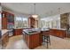 Modern kitchen featuring wood cabinets, stainless steel appliances, and marble countertops at 102 Anna Lake Ln, Cary, NC 27513